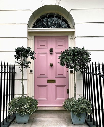 A charming pink door in London, warmly welcoming clients to collaborate with K&S Ventures and unlock new opportunities for their businesses